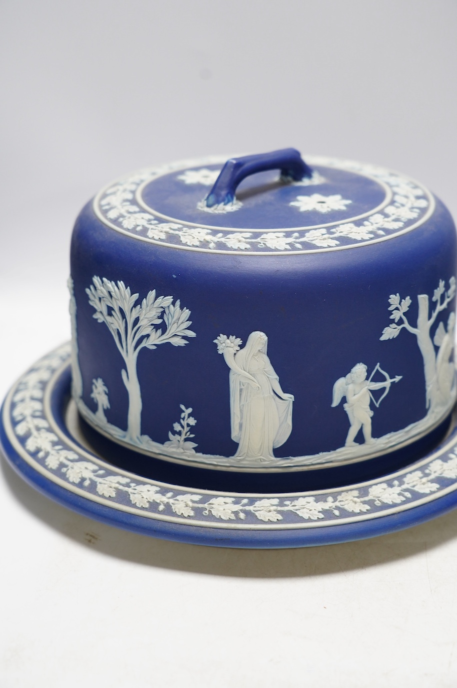 Two Wedgwood blue jasperware cheese dishes and covers, largest 29cm in diameter. Condition - good